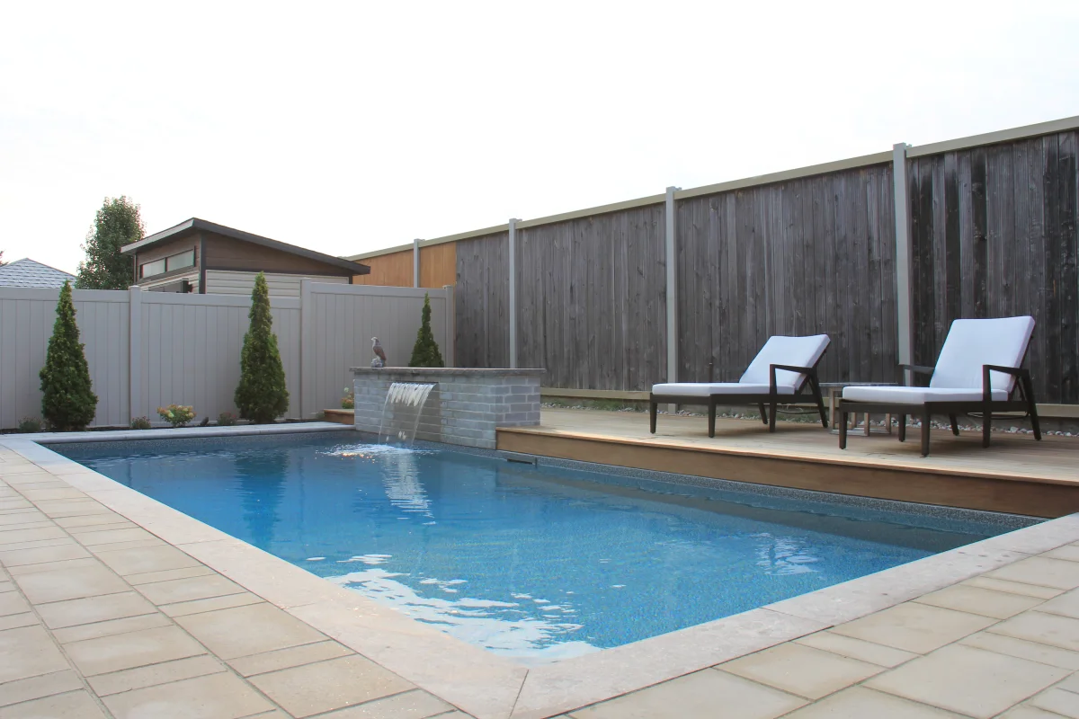 Mickelberry compact pool, waterfall wall and stone terrace