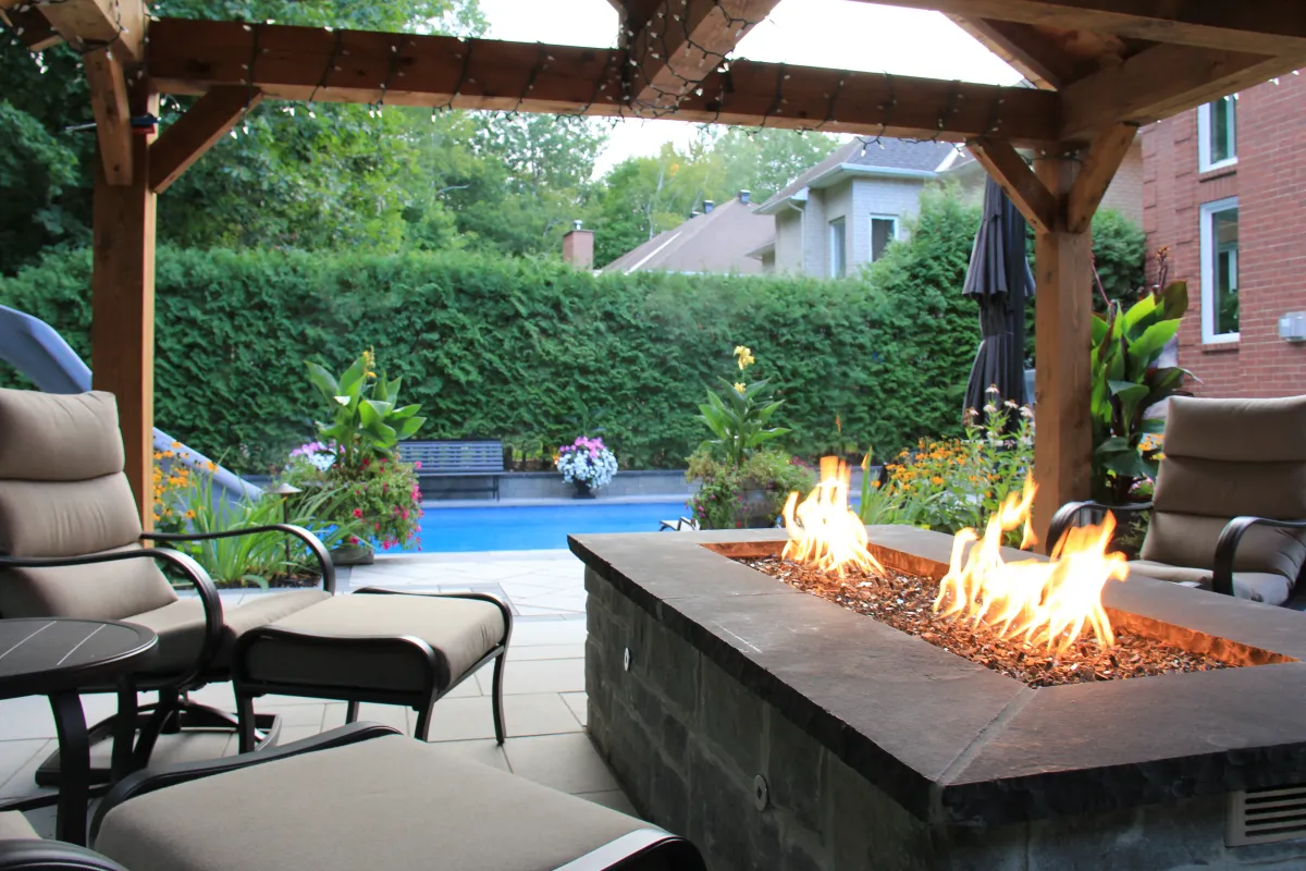 Rivercrest outdoor fire feature within the wooded landscape