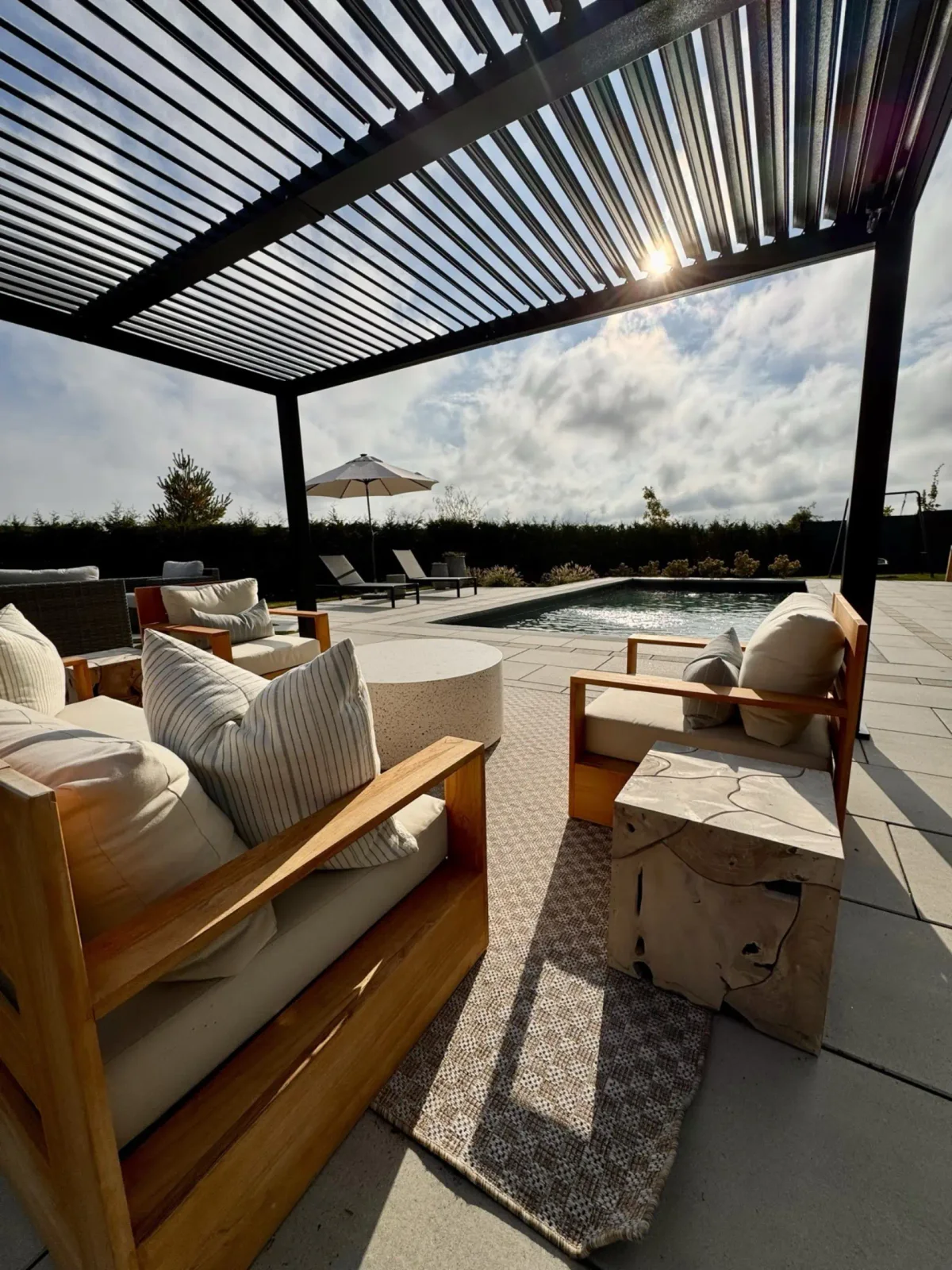 Louvered pergola sheltering a furnished outdoor room
