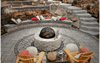 luxury backyard design with firepit and interlock stone