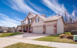 Beautiful two story home with intricate brick and stone interlocking driveway design