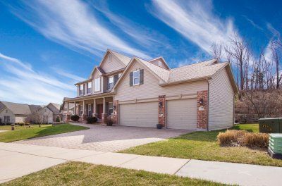 Beautiful two story home with intricate brick and stone interlocking driveway design