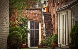 Shot of urban backyard with lots of greenery and interlocking stone