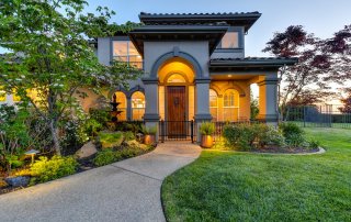 beautiful home with stunning landscaping complimenting the front entry
