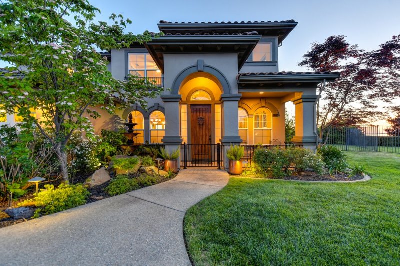 beautiful home with stunning landscaping complimenting the front entry