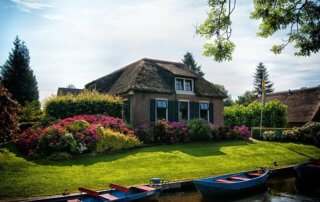 Home with manicured lawn and lush garden