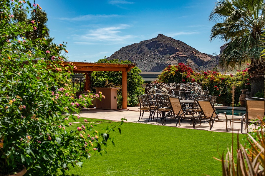 Tropical backyard with pool and mountain in the background