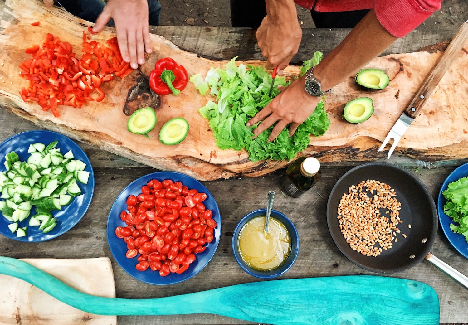 People chopping vegetables in outdoor kitchen