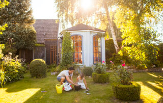 Father with daughter gardening in backyard