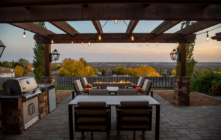 view of backyard home landscape under pergola with outdoor kitchen and dinning area