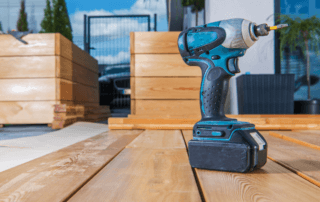 hand drill on the floor of new wood flooring next to new plant boxes